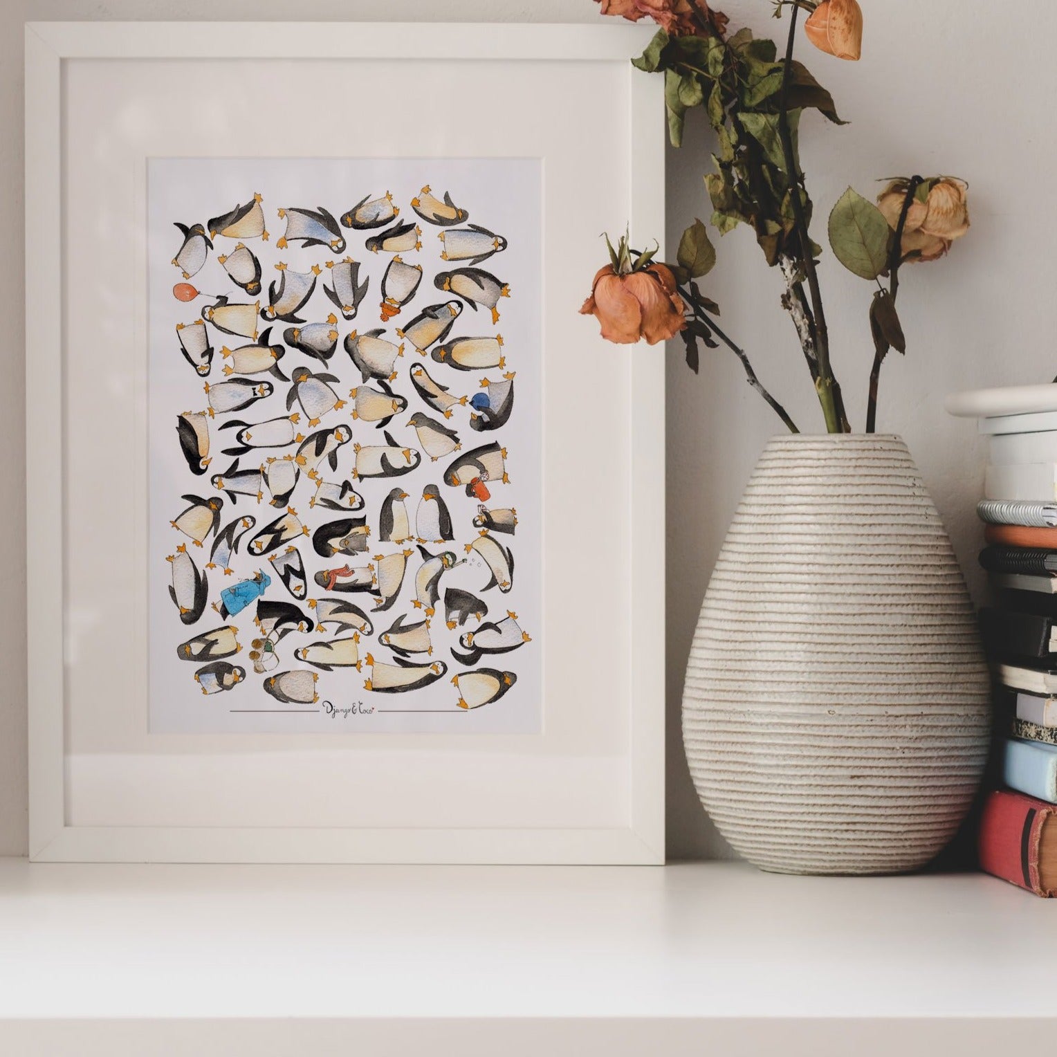 Penguins watercolor art on a shelf with a vase